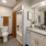 Staged bathroom with orange shower curtain