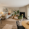 Staged living room, dining area, and kitchen with bar stools