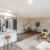 Staged apartment living and dining areas with view of kitchen