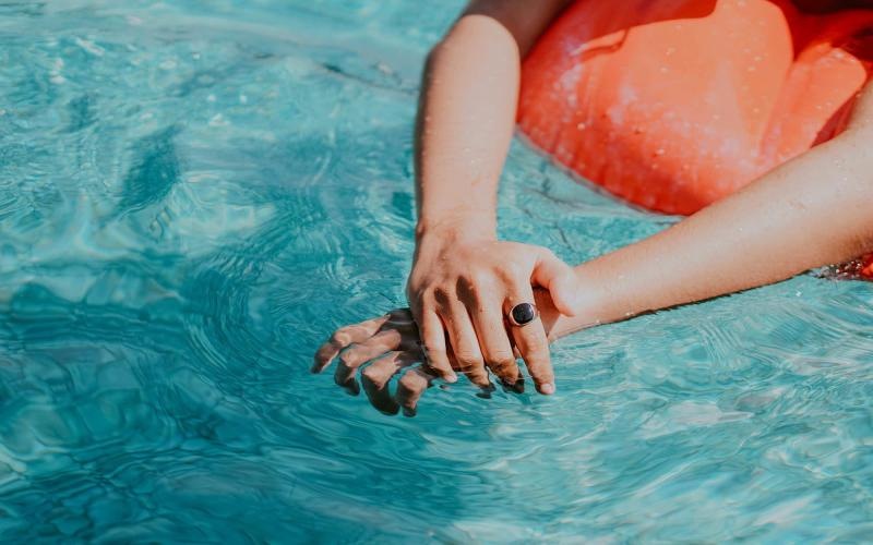 woman relaxes on a floatie in swimming pool